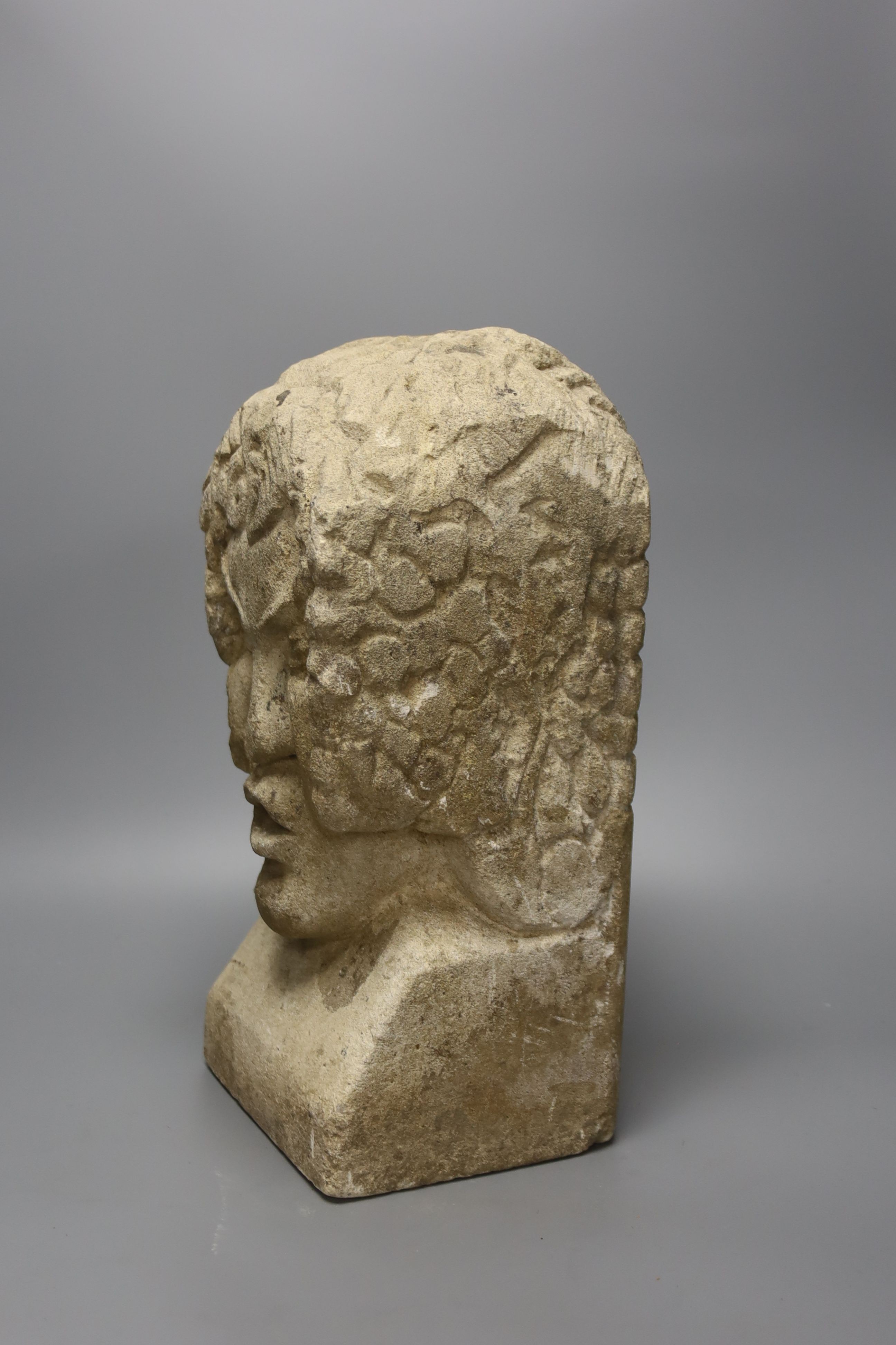 A carved sandstone grotesque bust, stonemason’s mark to back, 36cm